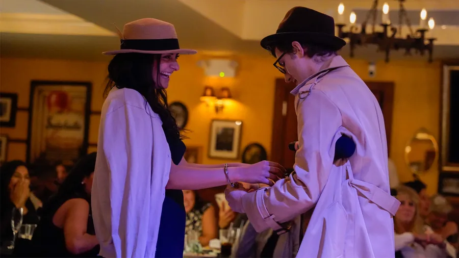 A Murder Mystery Company detective questioning a guest at a Charlotte show