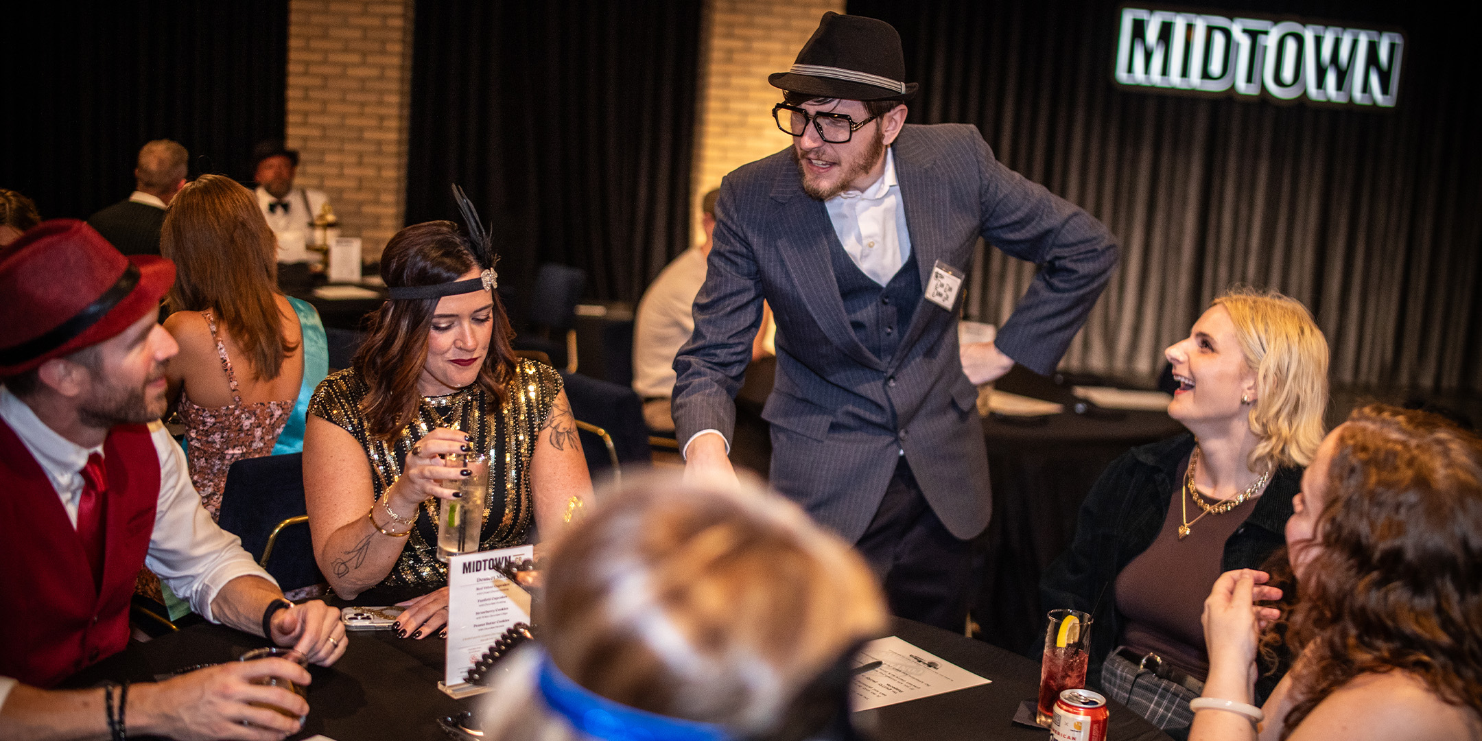 Guests at a Murder Mystery Company public dinner show in Charlotte